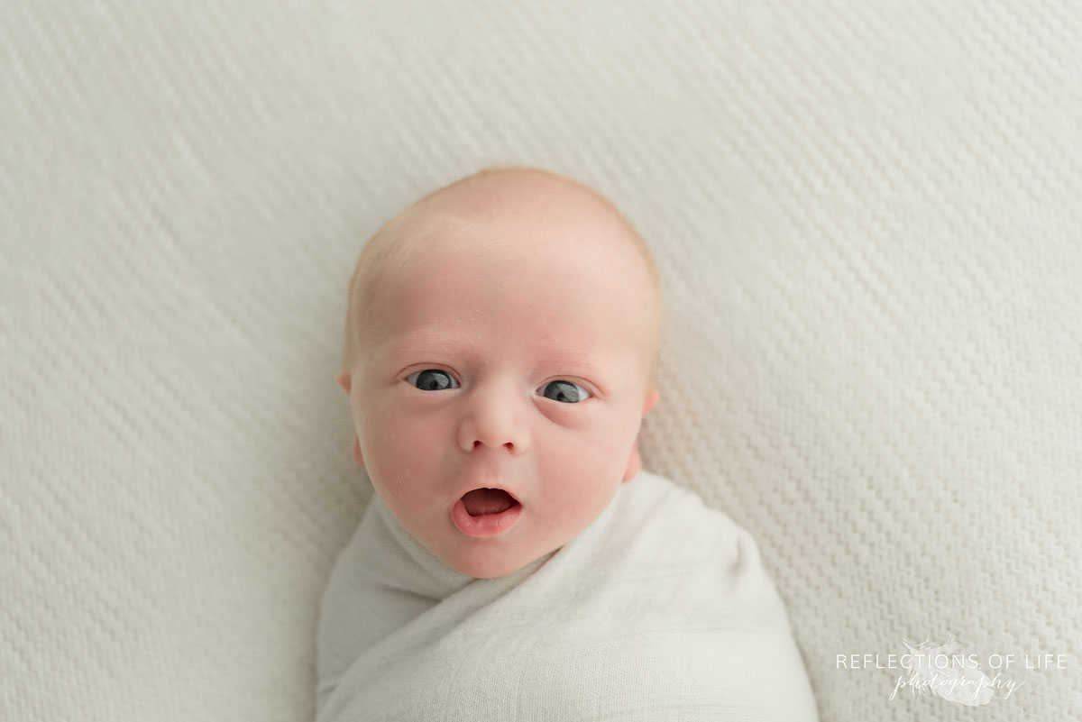 Newborn baby makes WOW face Baby boy photography Ontario Canada