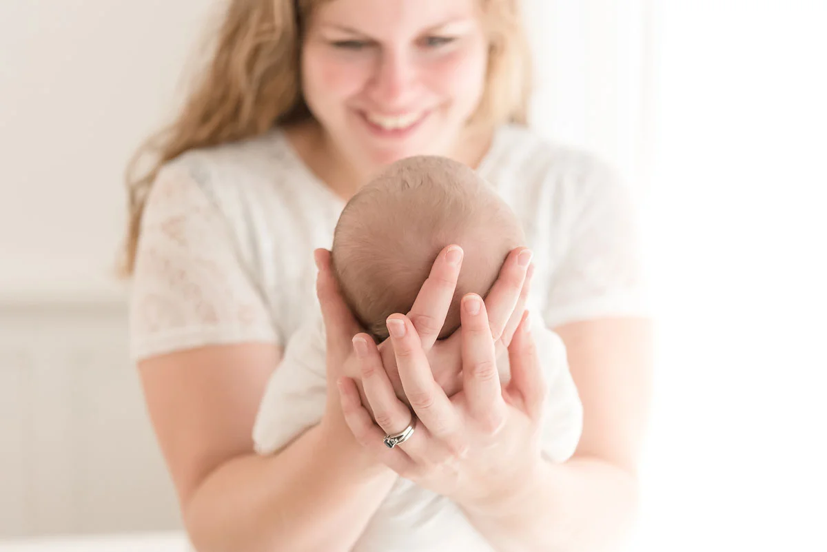 white lace dress on mama holding newborn baby
