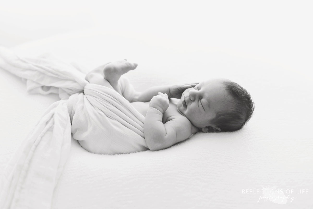 Newborn baby boy sleeping on beanbag in Grimsby Ontario photo studio
