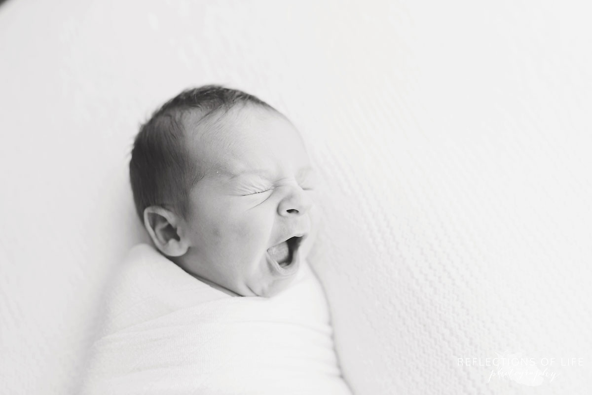 Newborn baby boy yawn