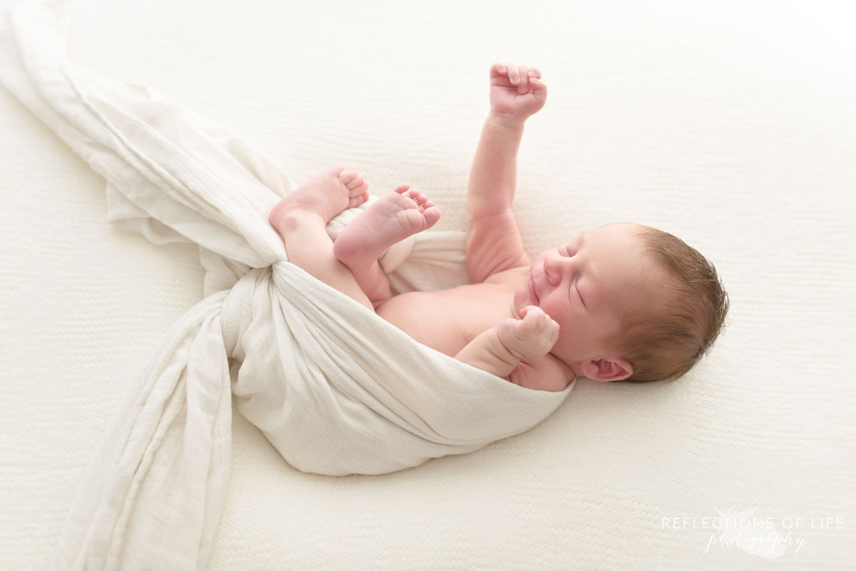 Newborn baby posing as Superman Niagara Newborn Photographer Ontario