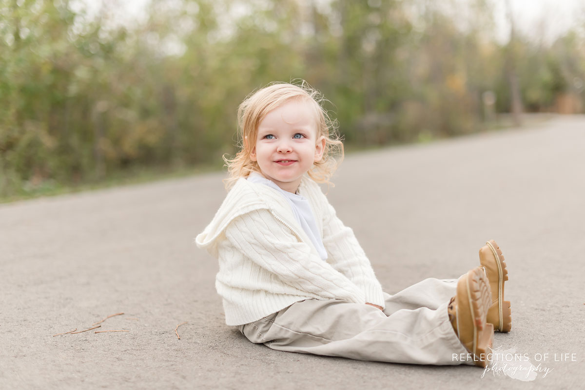 Professional Niagara Family Photography of little boy sitting on pathway in Grimsby Ontario.jpg