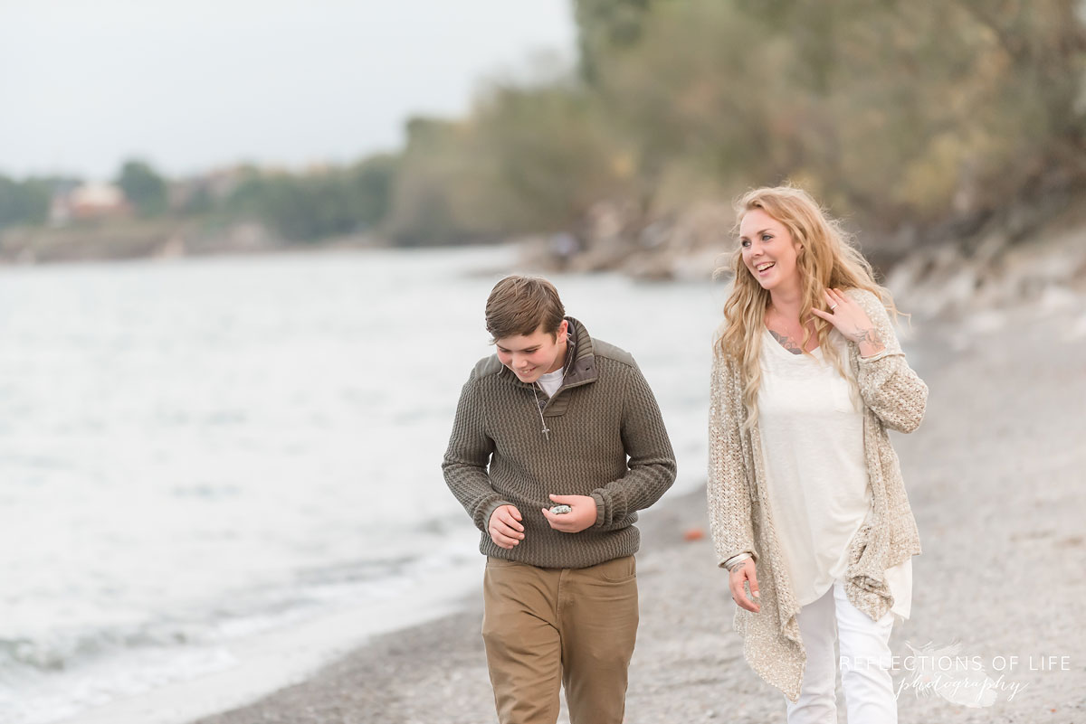 Mother and son laughing as they walk down the beach.jpg