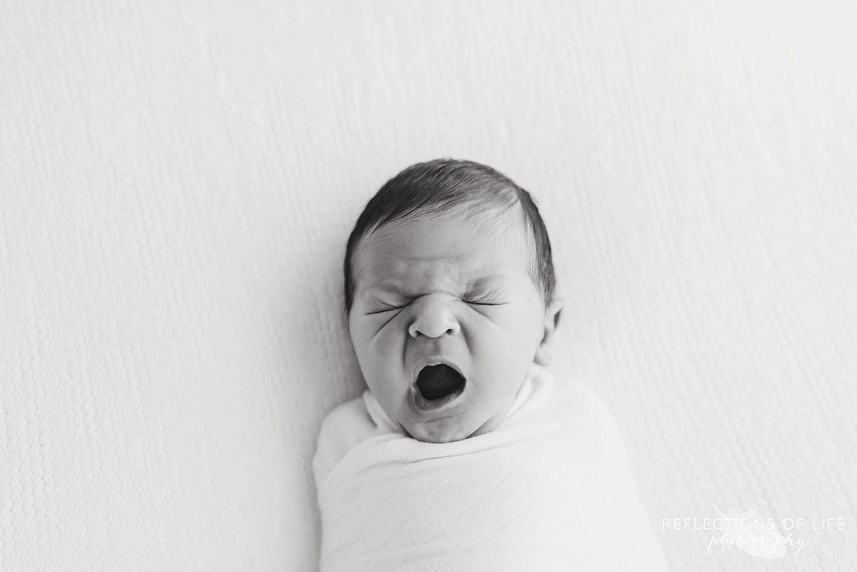 Professional photos of newborn babies yawning