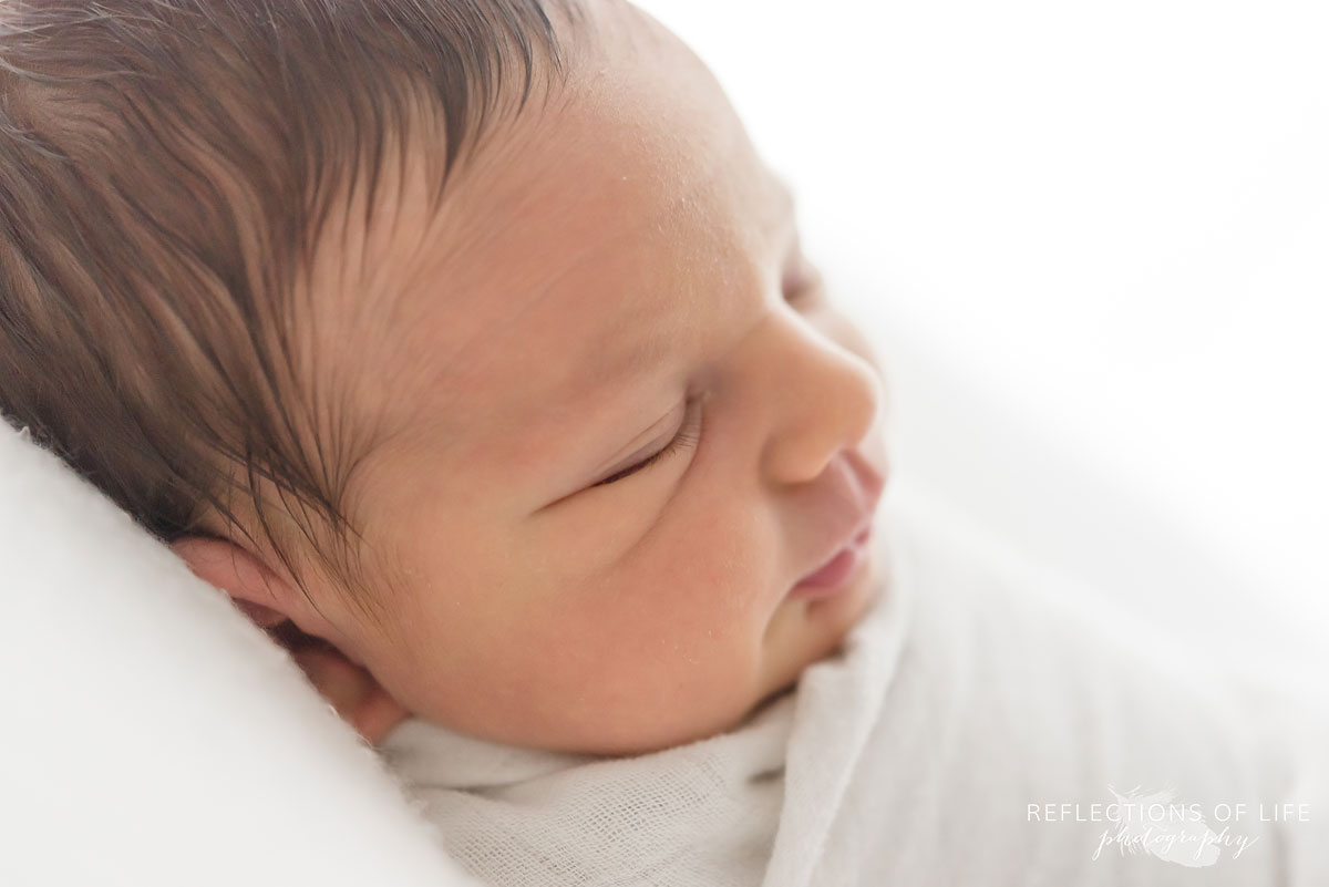 Colour photo of a newborn baby side profile