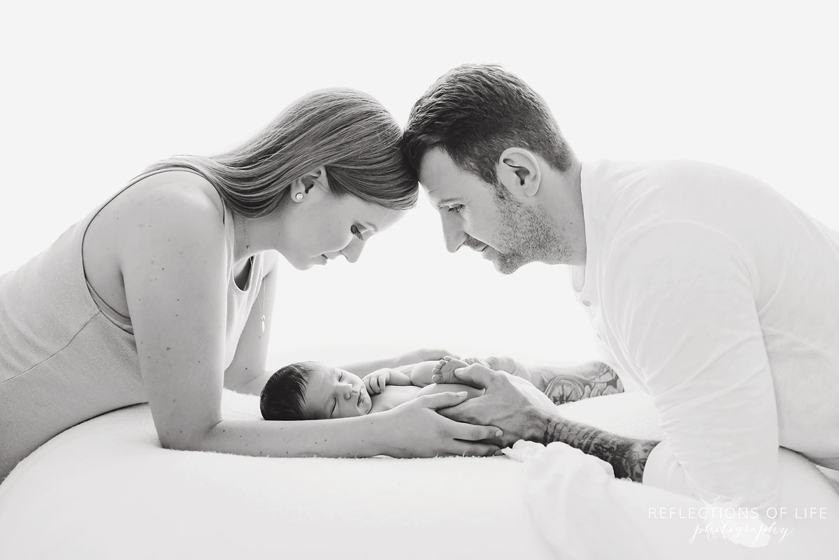 Black and white photo of newborn baby boy and his parents