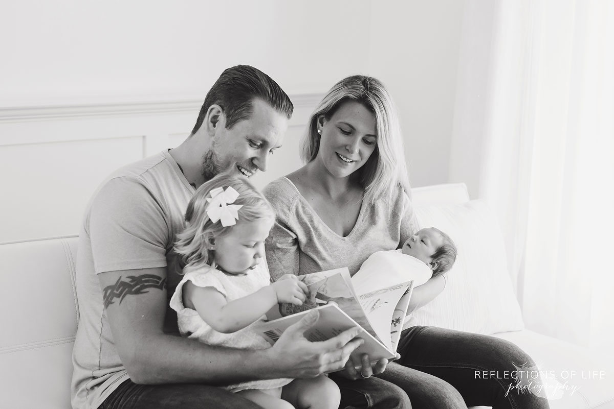 002 Family photography of family and newborn baby in white walled Grimsby Ontario studio.jpg