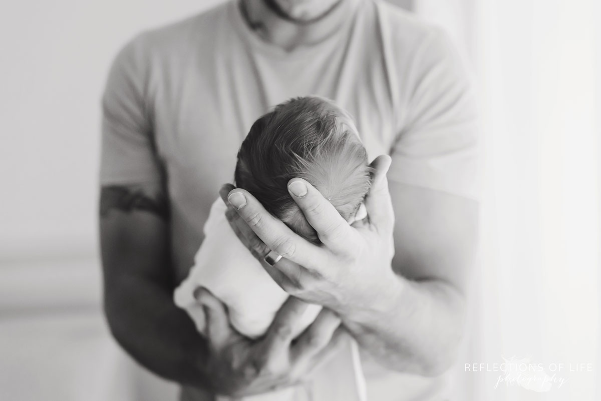 009 Black and white photo of Dad looking down at newborn baby.jpg
