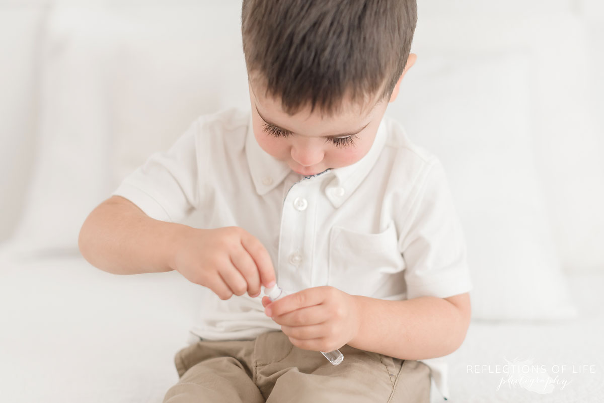 Colour photo of little boy blowing bubbles