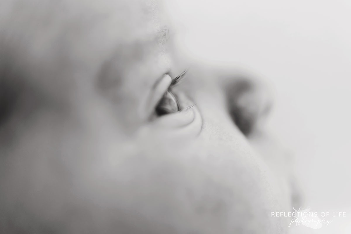 Side profile view of newborn baby eye and eyelashes
