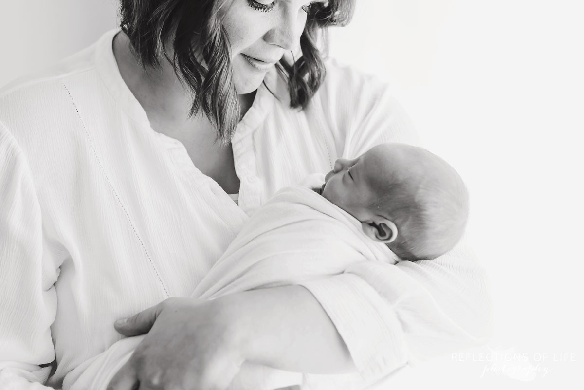 Mom and newborn baby boy in black and white
