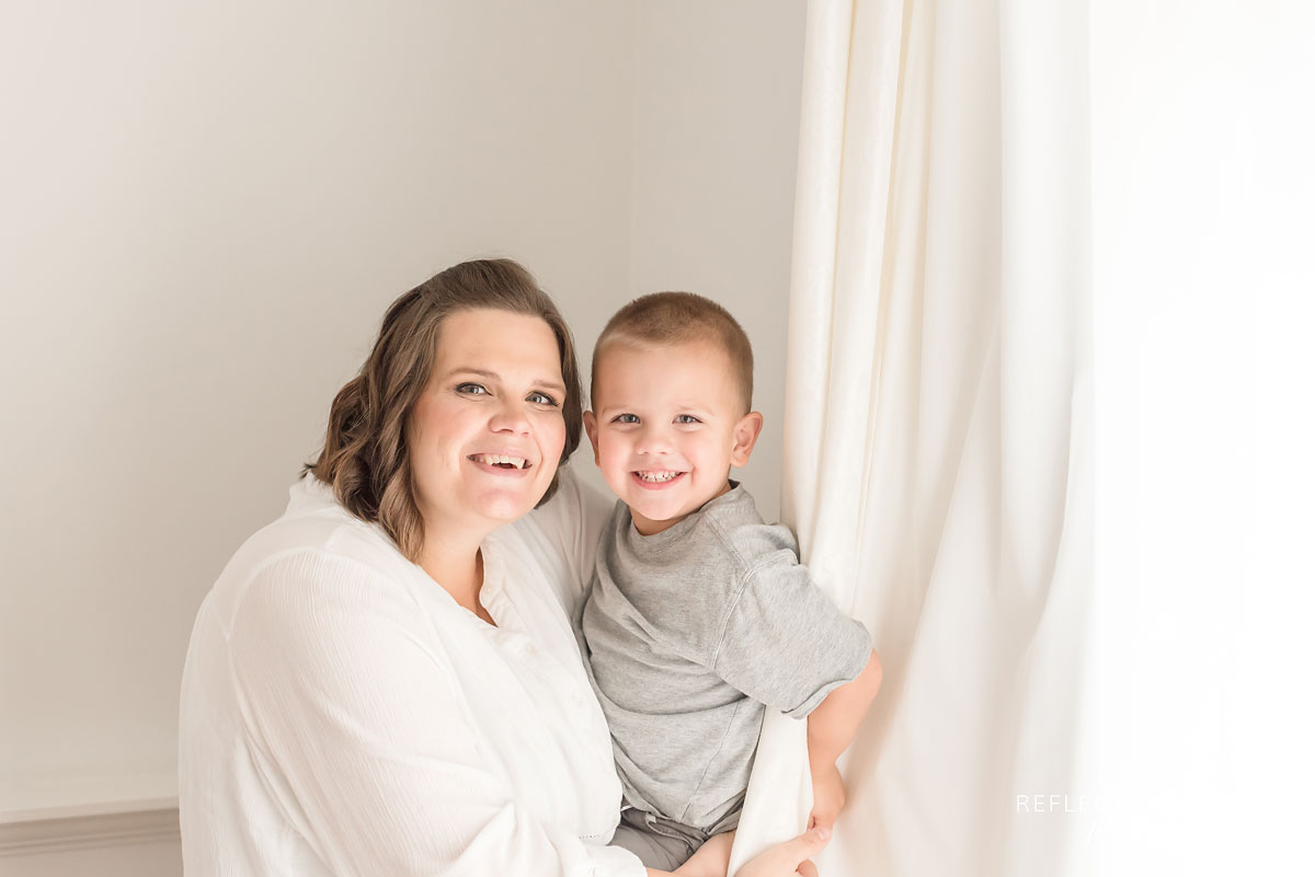 Mother and son laughing and posing for the camera