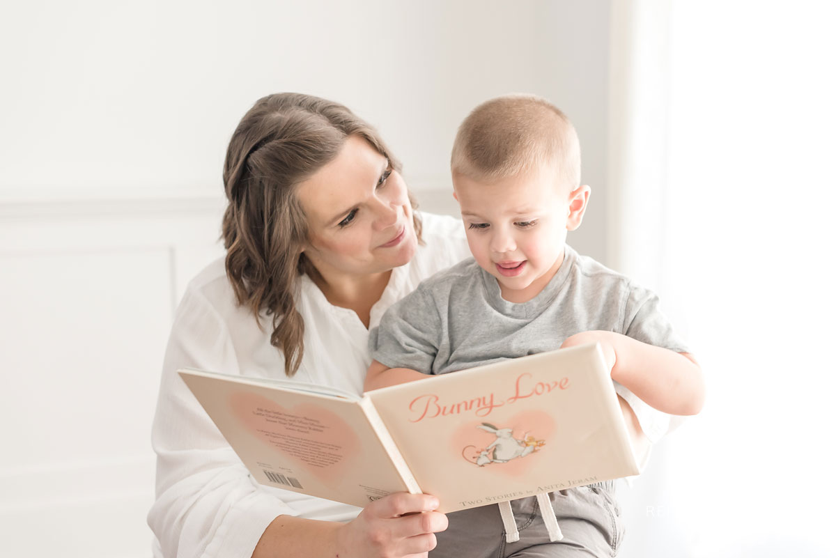 Mother and son reading a book together