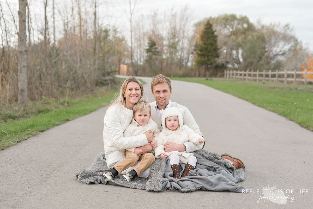 Colour photo of family huddled together for warmth