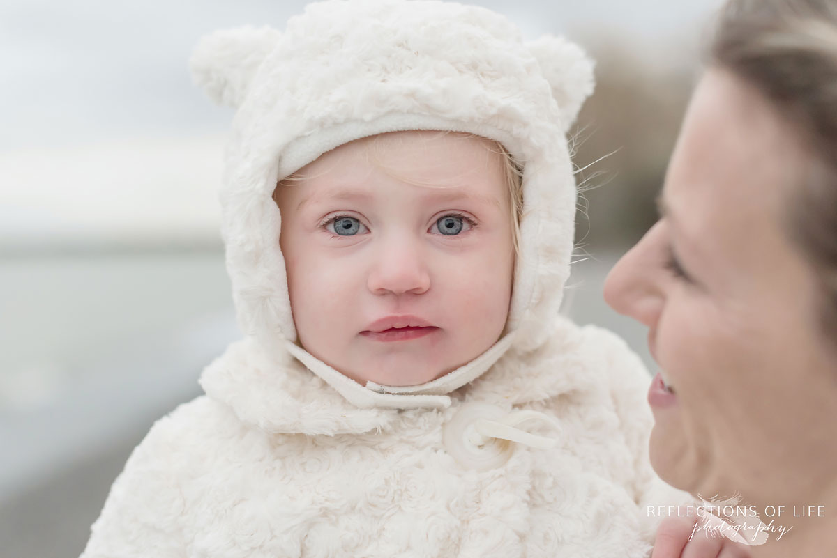 Little girl portrait on the beach in winter