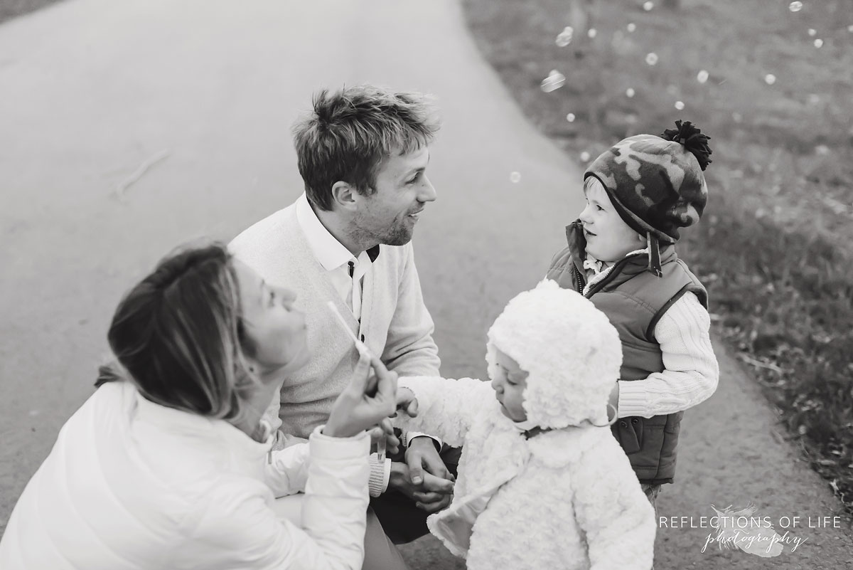 Famliy blowing bubbles on a pathway in Niagara Ontario Canada