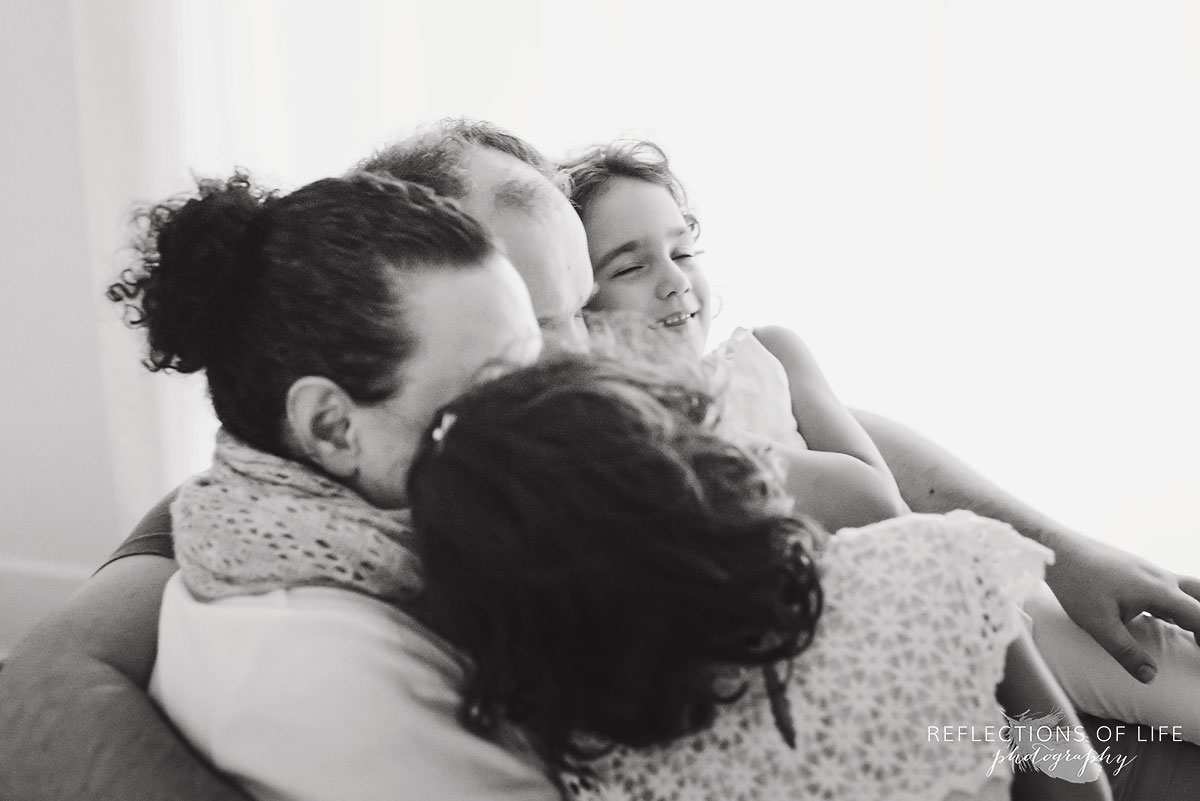 twins in parents laps black and white