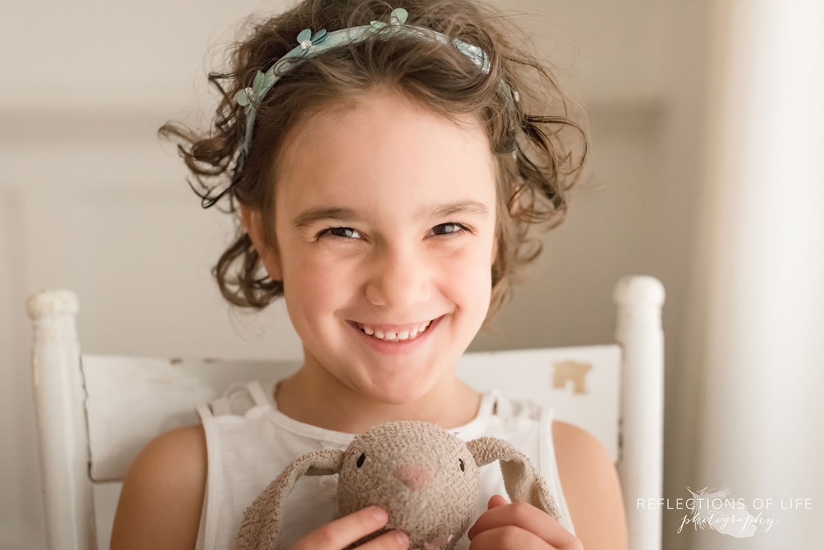 young girl smiling holding bunny