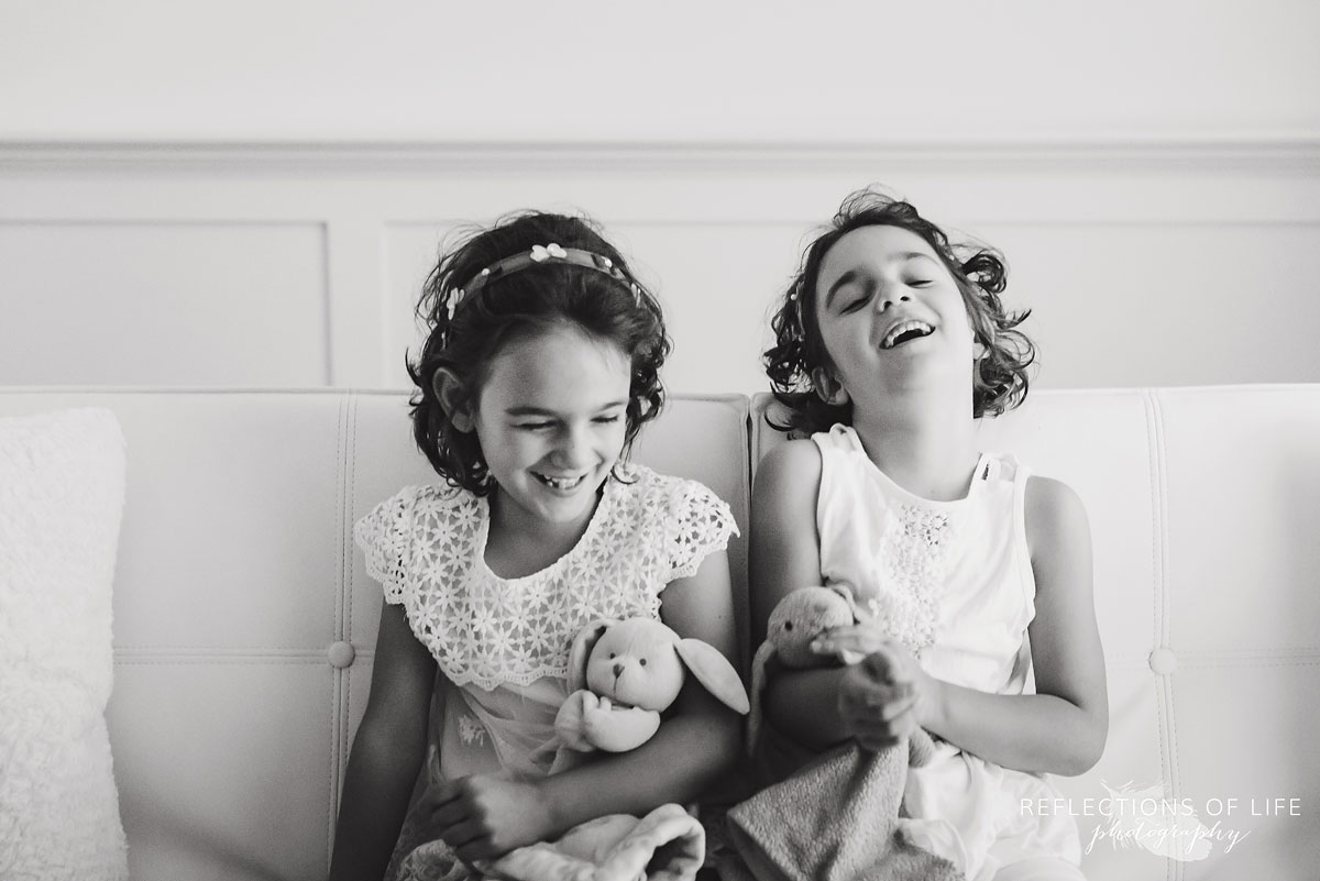 twins sitting beside eachother black and white