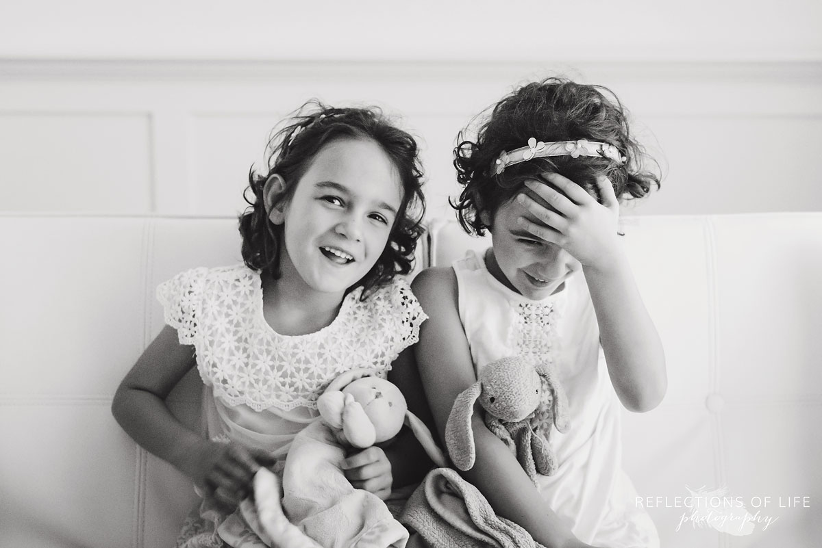 twins holding bunnys black and white