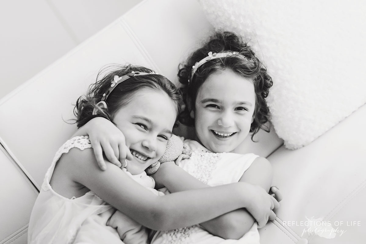 twins hugging black and white