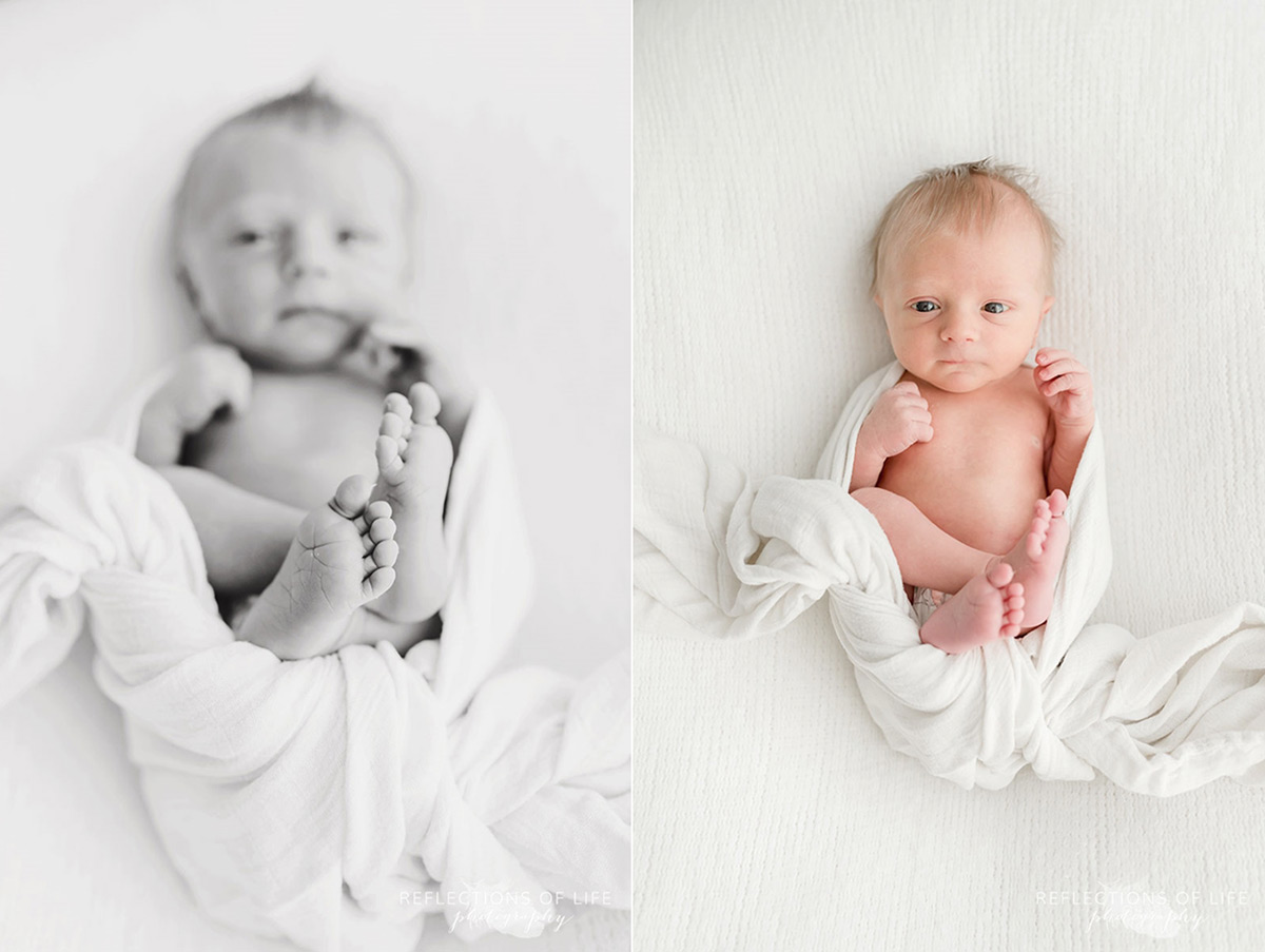 new born baby laying on blanket half black and white