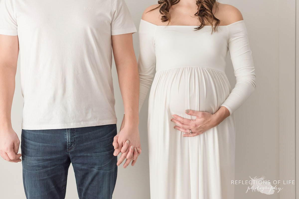 mother and father to be holding hands