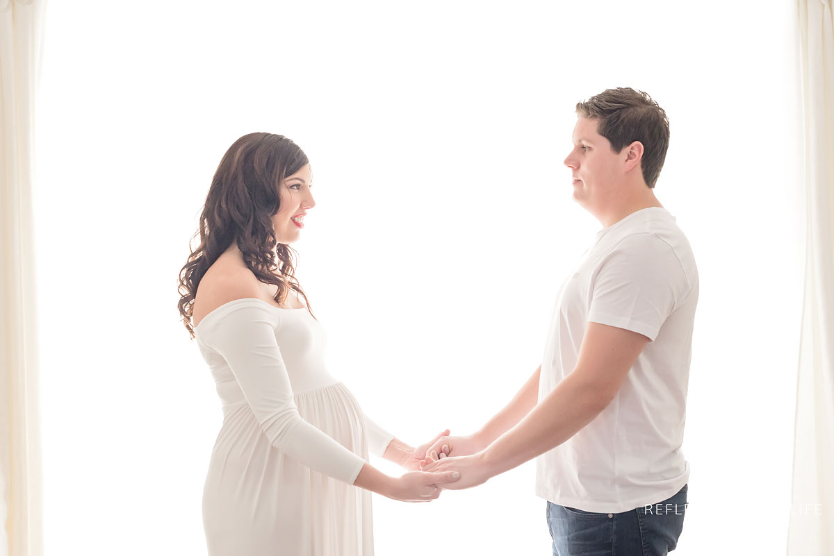 parents to be smiling holding eachothers hands