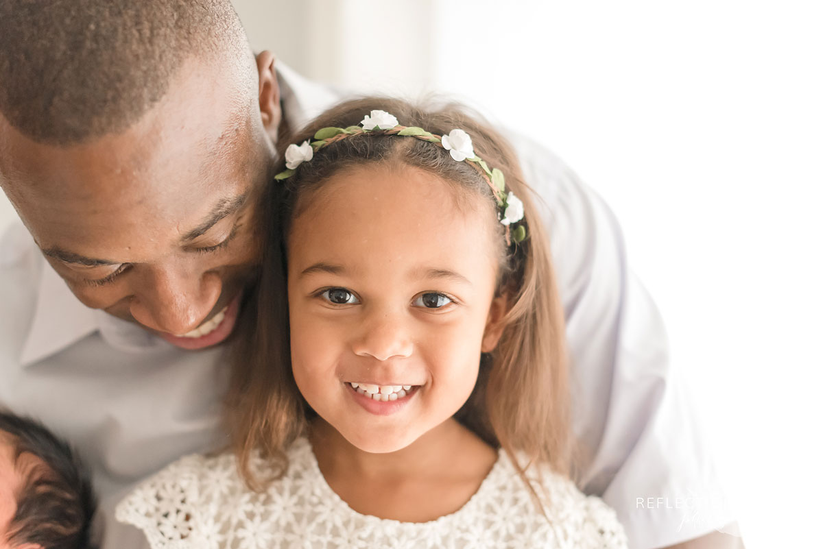 young girl sitting on fathers lap