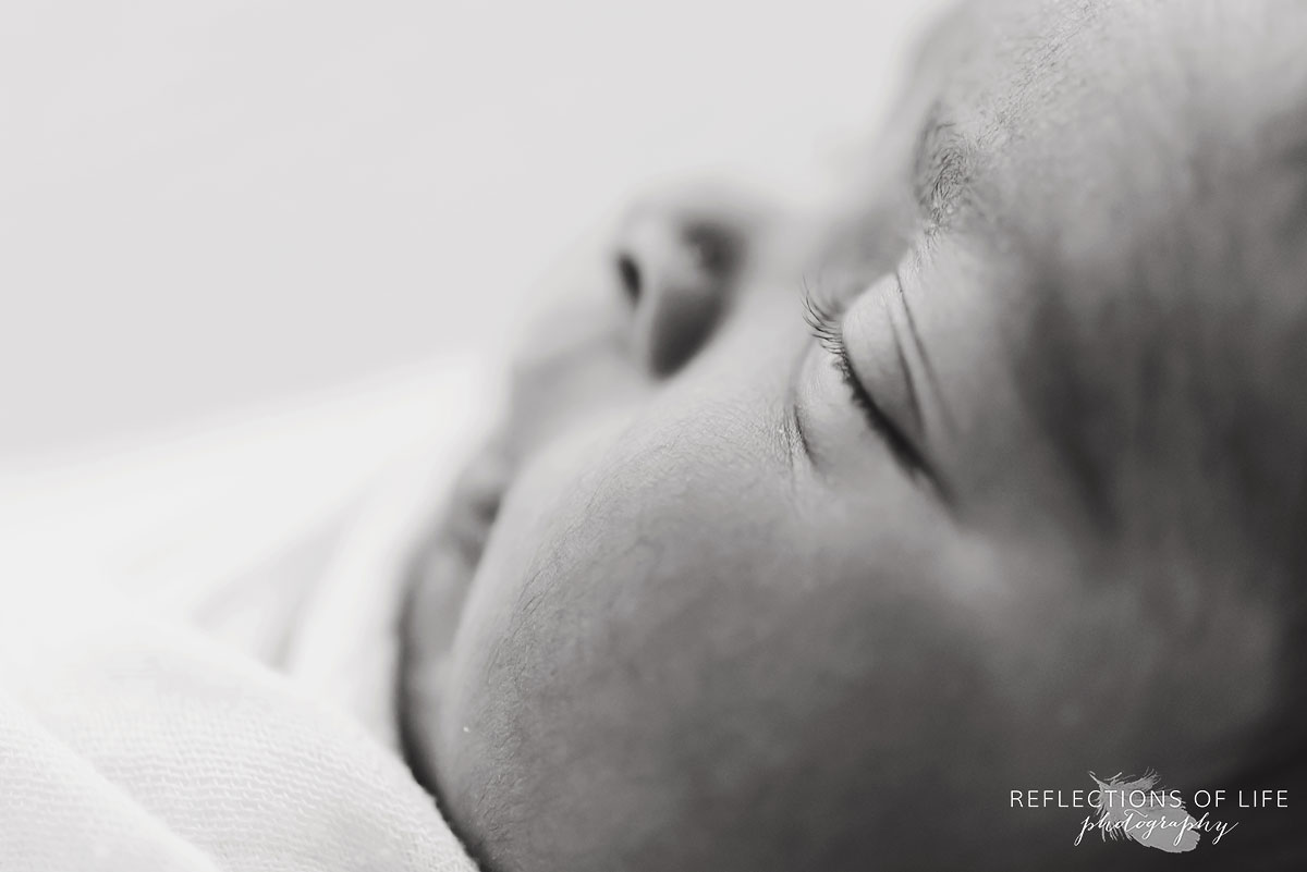 black and white baby up close cheeks black and white