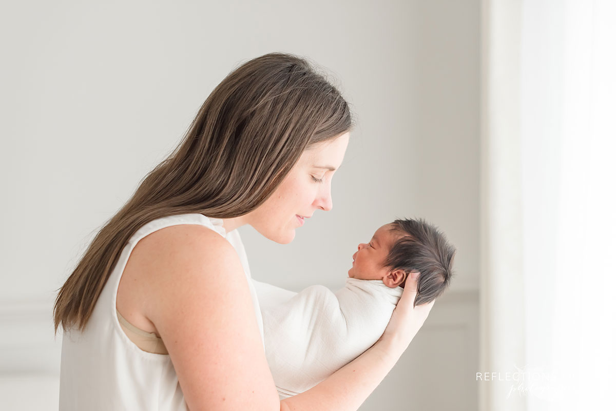 mother holding newborn in arms