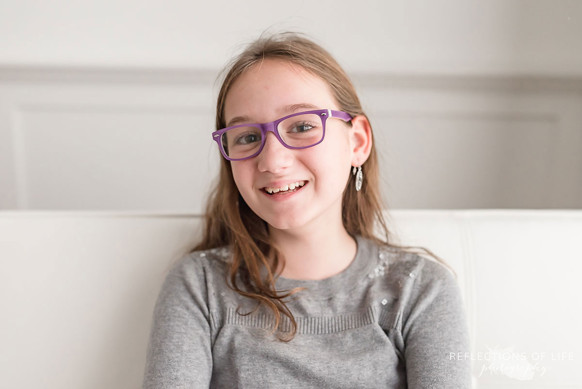 happy young girl wearing glasses smiling