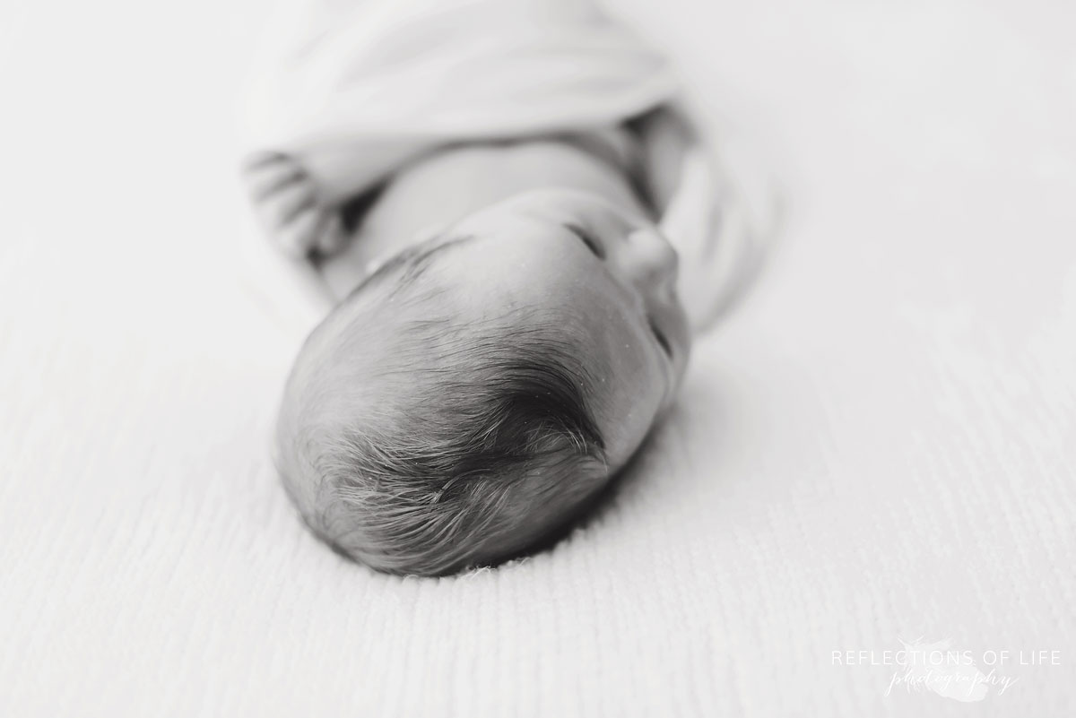 young baby boy newborn hair detail black and white