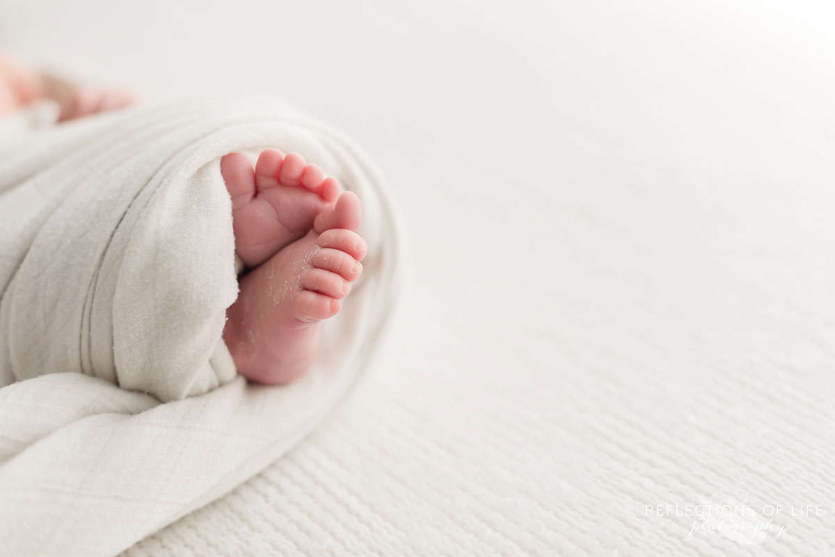 newborn baby boy feet detail all white room