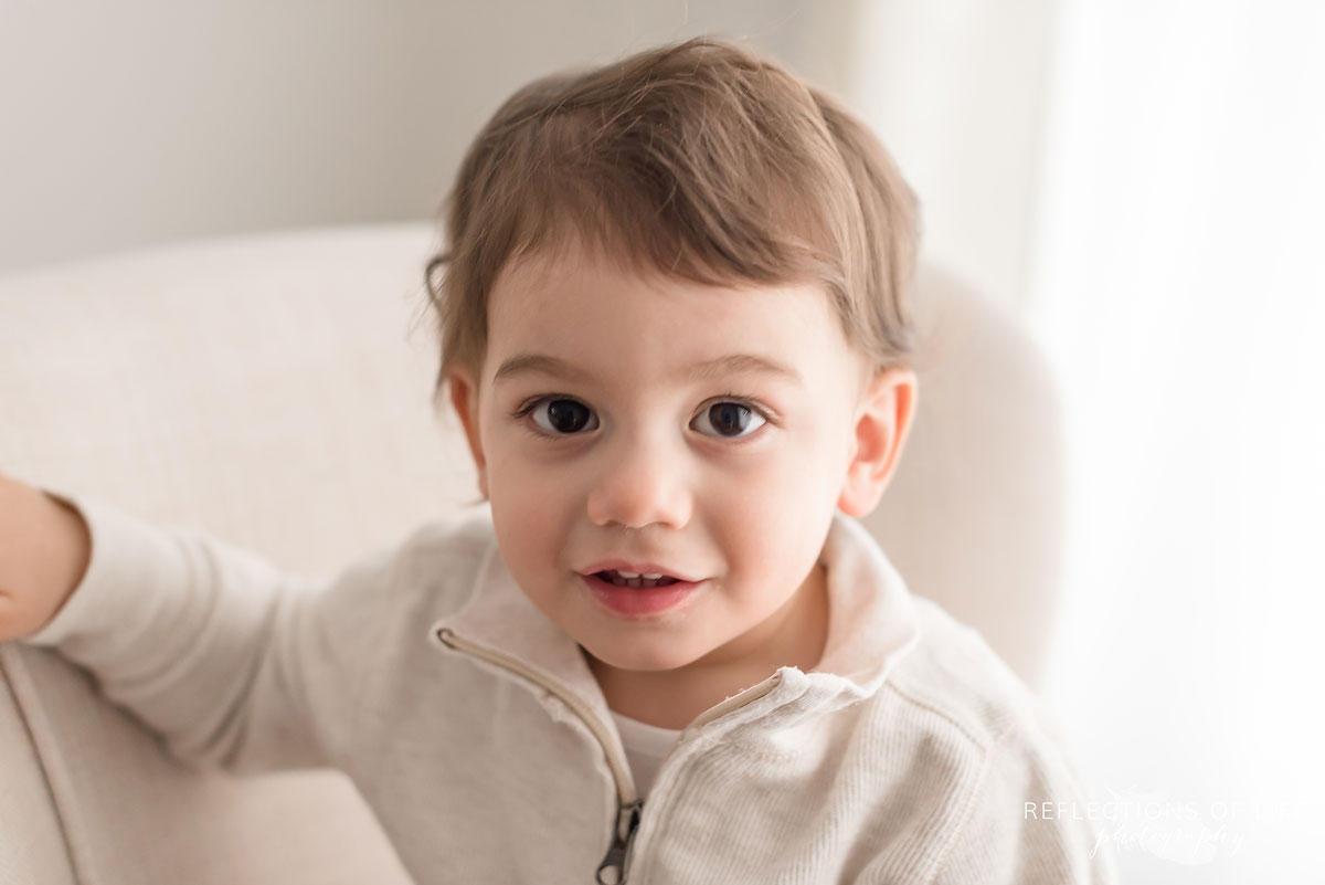 Adorable young boy in natural light studio