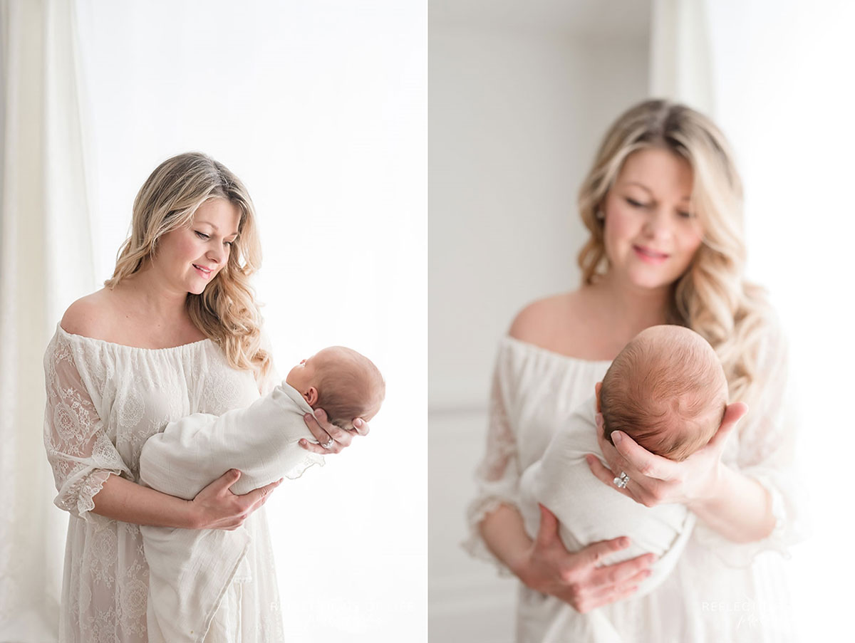 Mother smiling holding newborn baby girl