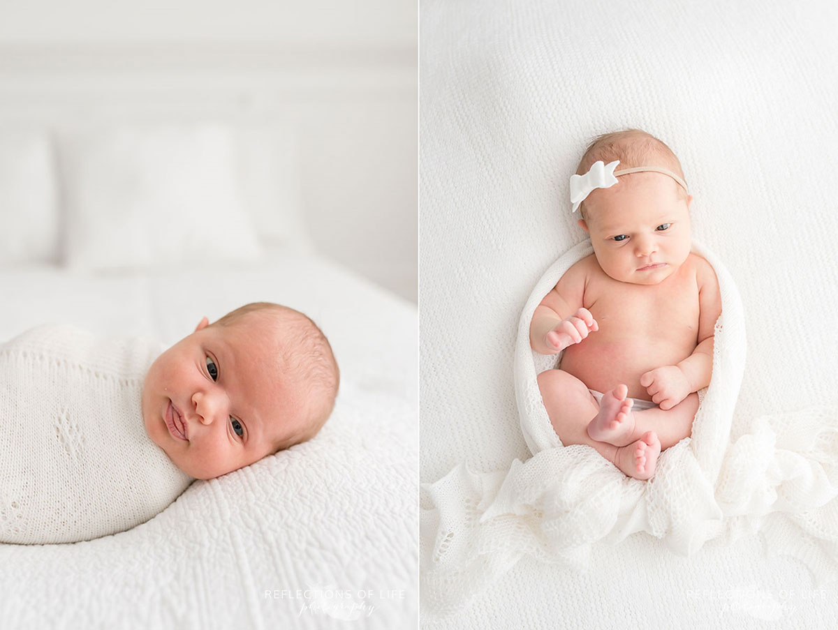 newborn baby girl laying on bed looking into camera