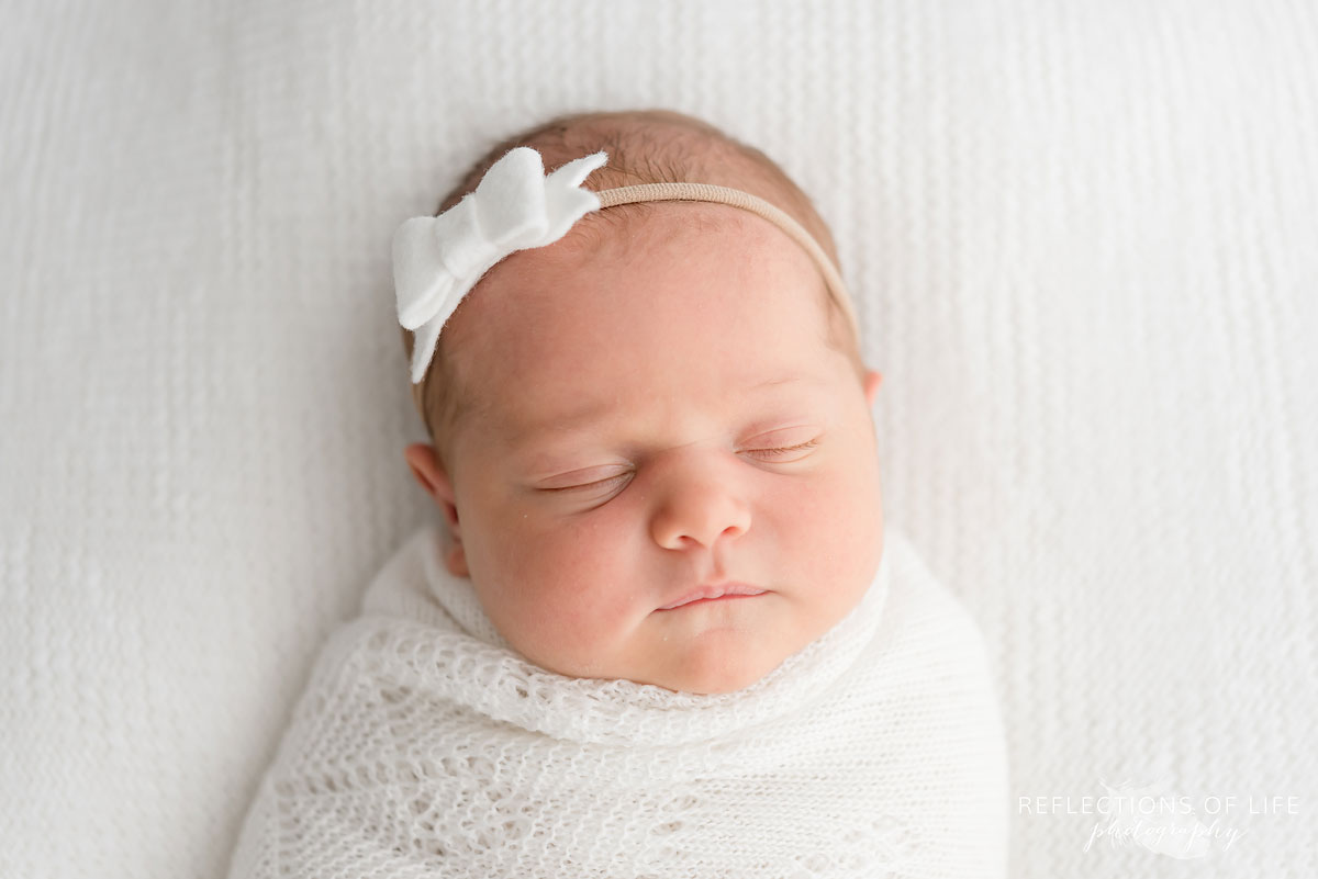 newborn baby girl wearing headband