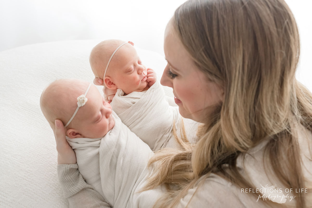 newborn baby girls in their mothers arms