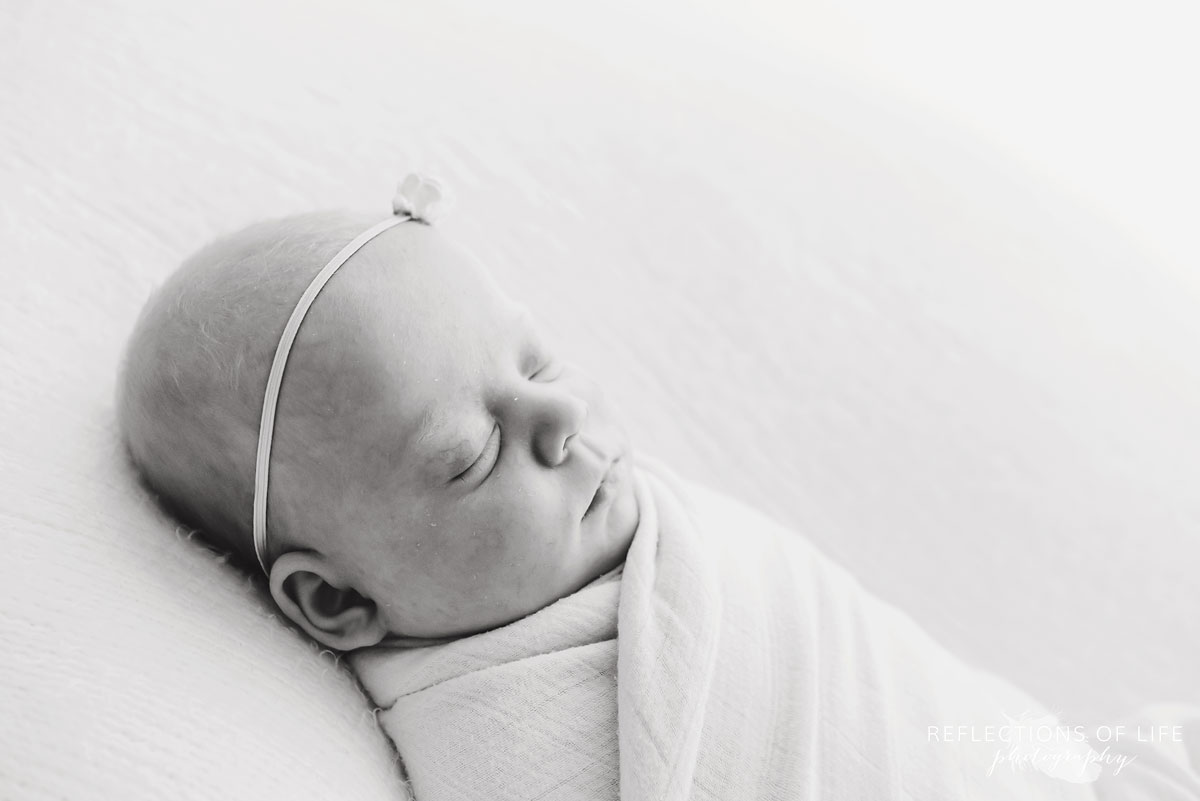 newborn baby girl sleeping black and white