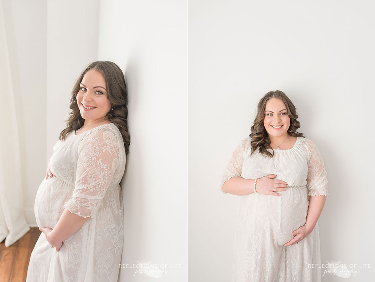 Pregnant mama holding her belly in white walled studio