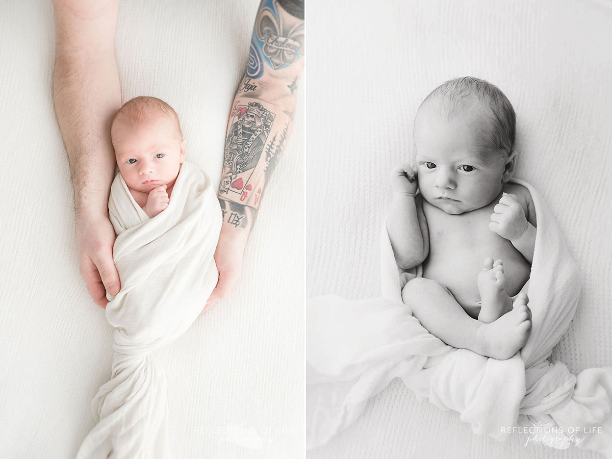newborn baby boy with wide open eyes swaddled in white