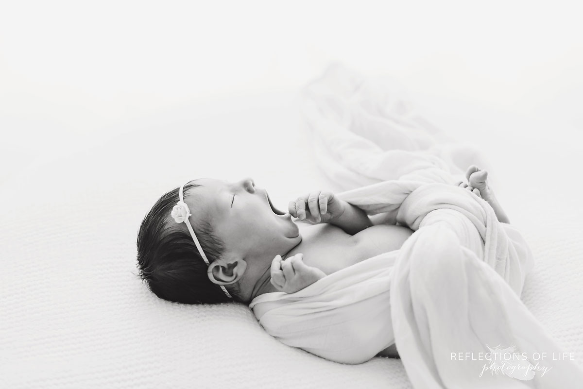 Newborn baby yawn in black and white