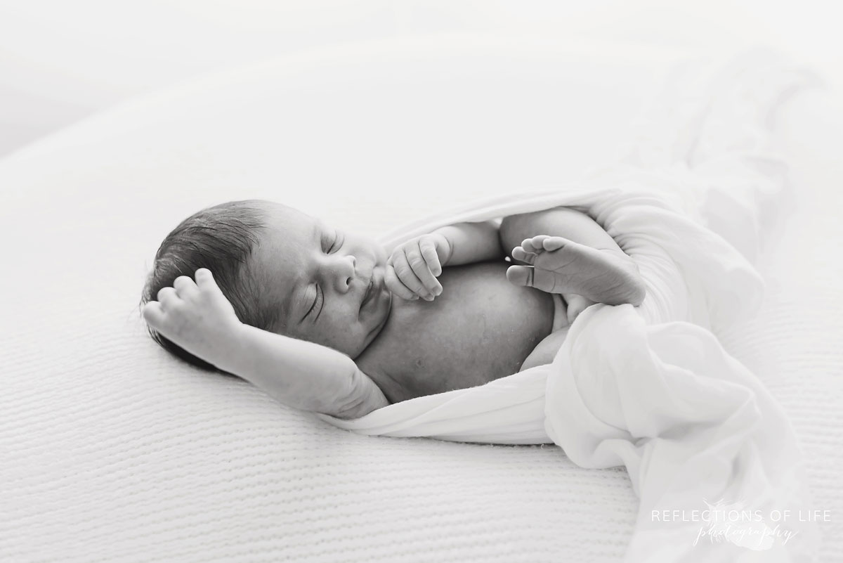 Newborn baby girl relaxing and resting on beanbag