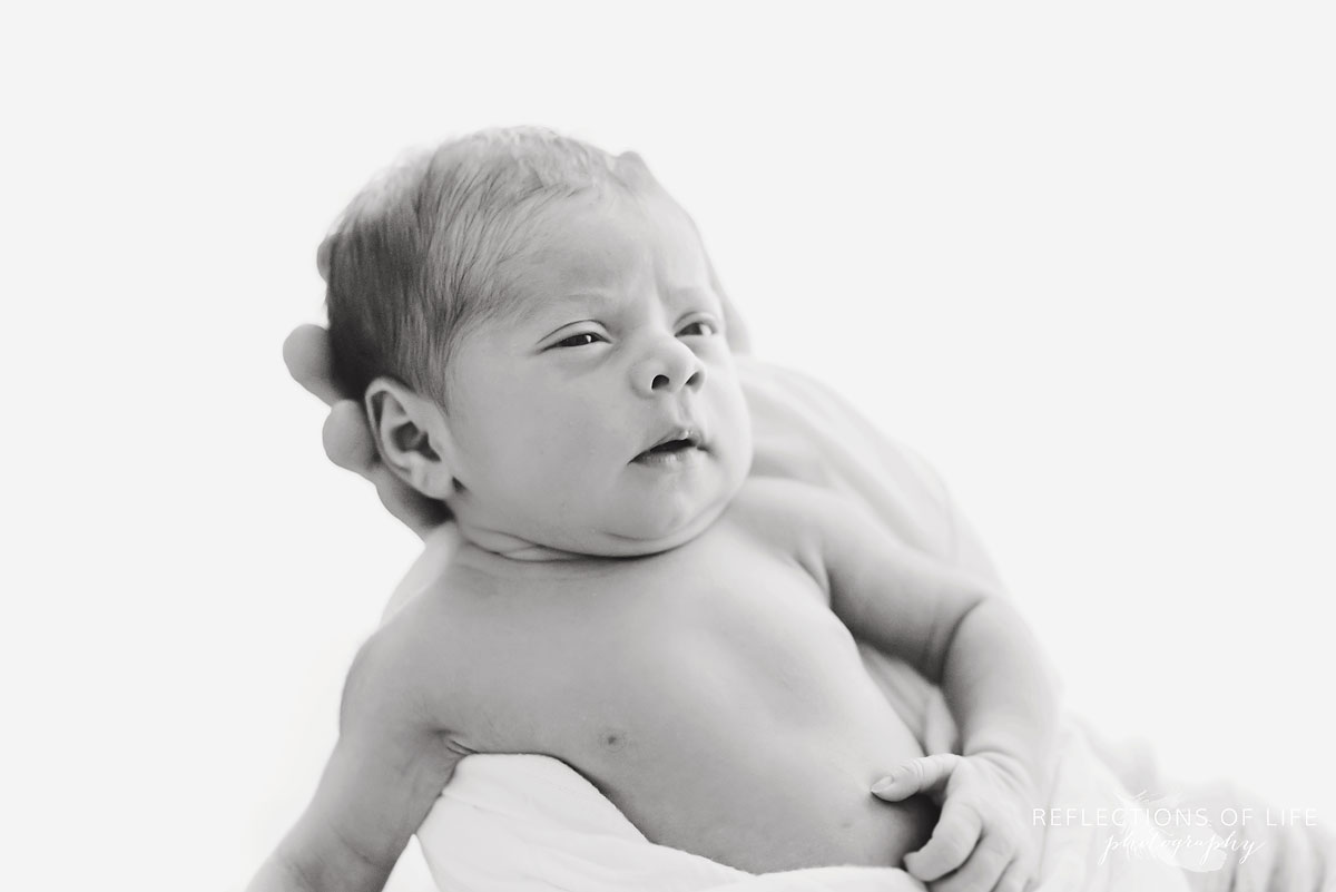 Newborn baby girl in her daddy's hands