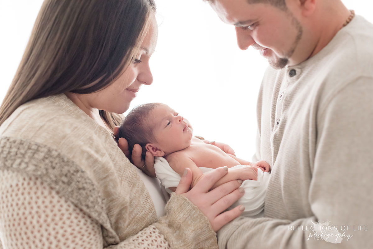 Close up of newborn and family during newborn photography session