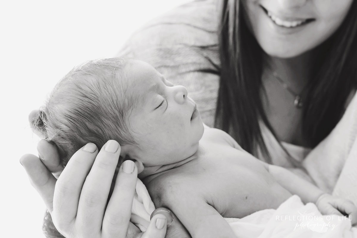 adorable baby girl sleeping in parents hands