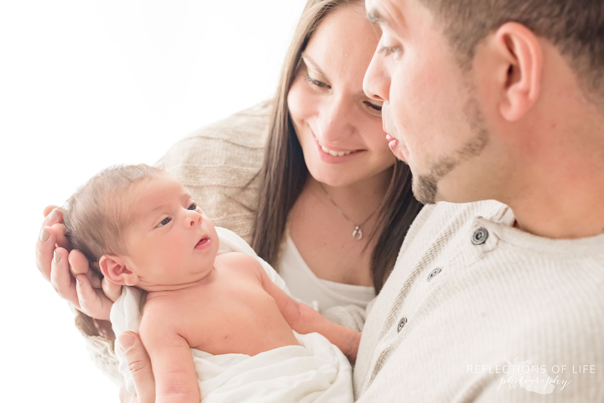 baby girl wakes up and looks up at her daddy
