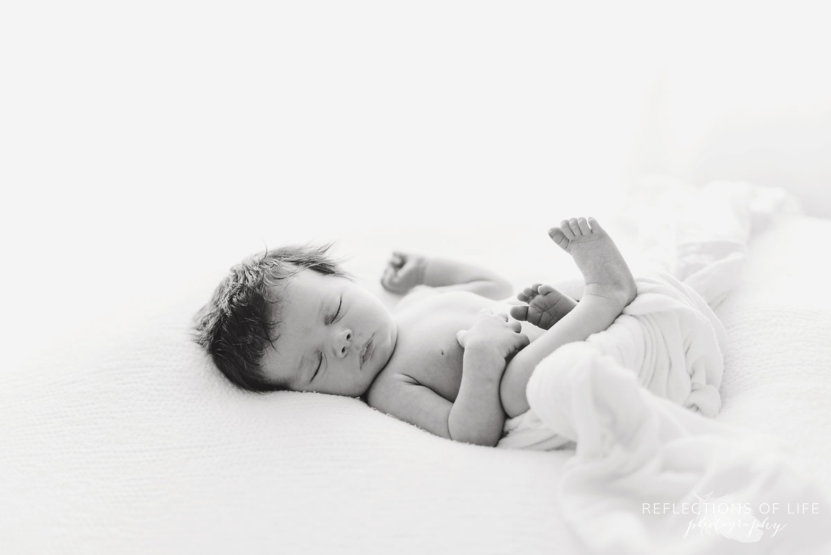Newborn baby girl in black and white