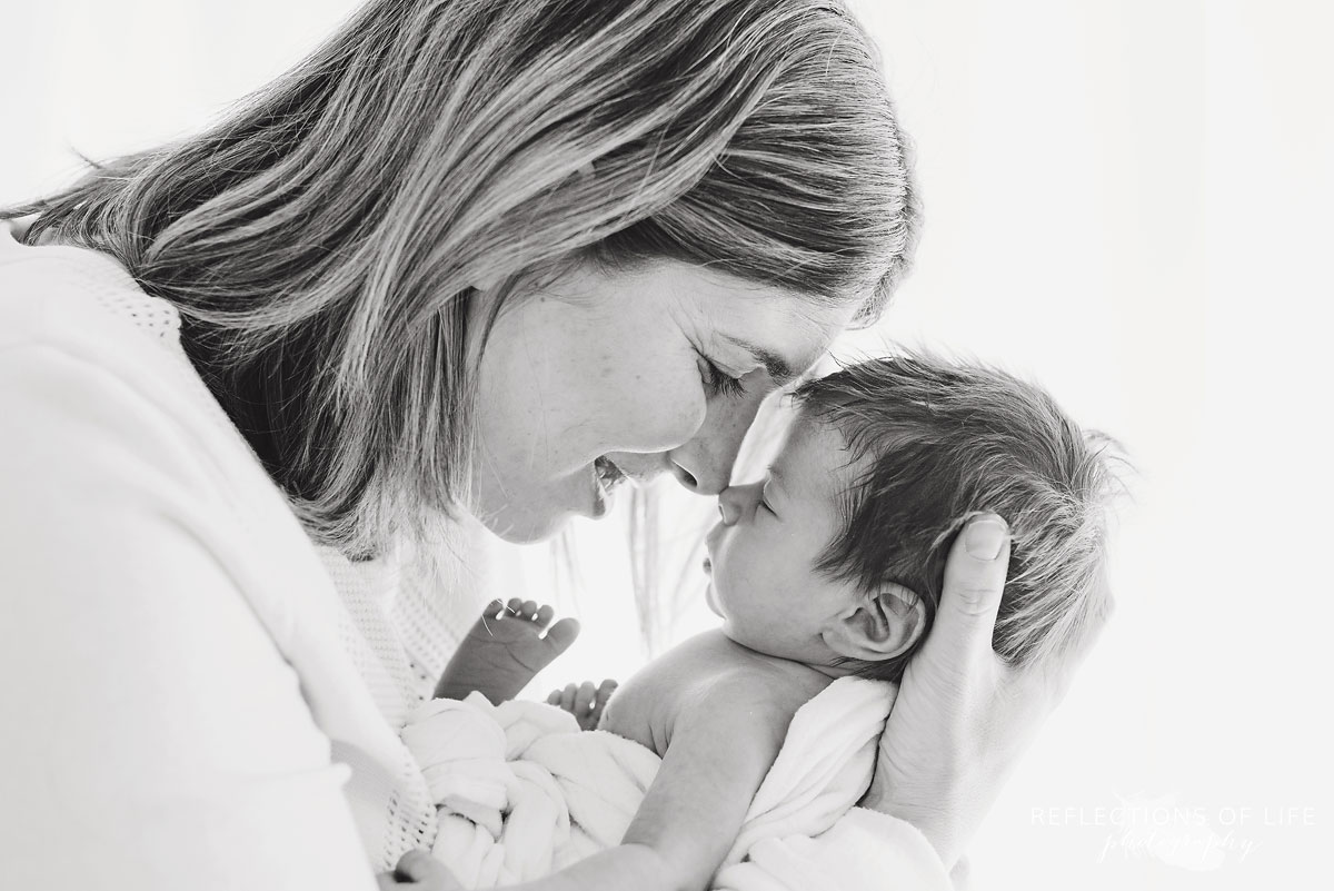 Mother and newborn baby girl daughter in black and white